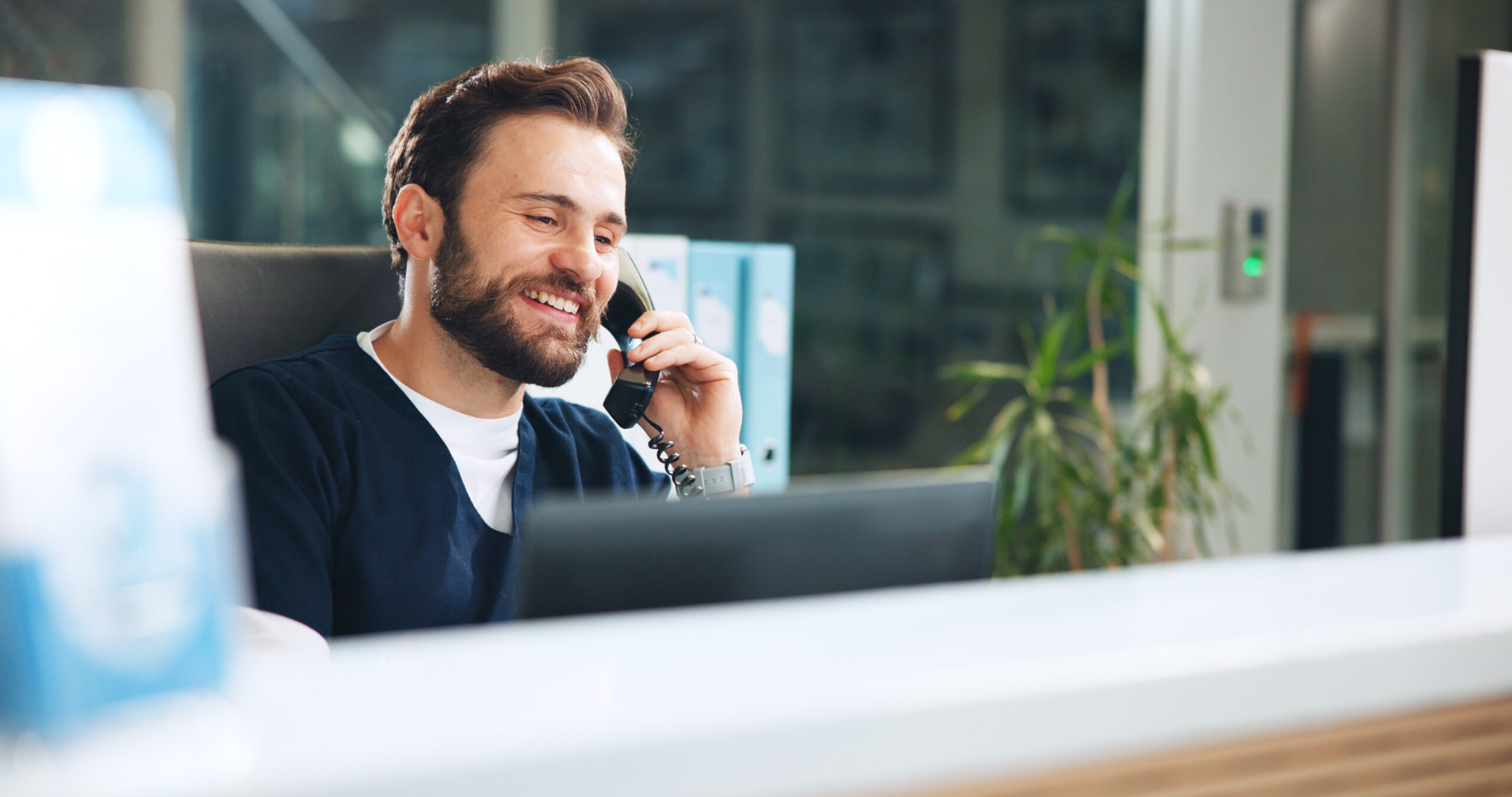 Man, doctor and phone call in hospital with smile, medical advice and update patient appointment. Healthcare, specialist and talk with technology for schedule, friendly service and help at front desk.