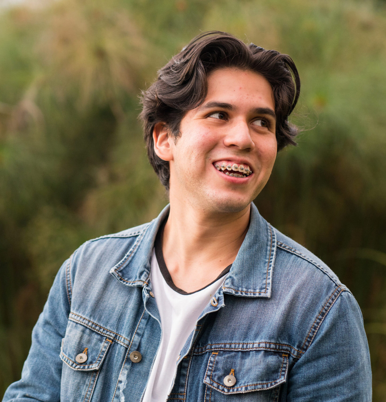 self-confident person with braces and acne. young man with acne confident, smiling. hormonal changes and adolescent problems. skin conditions. hard times for the young