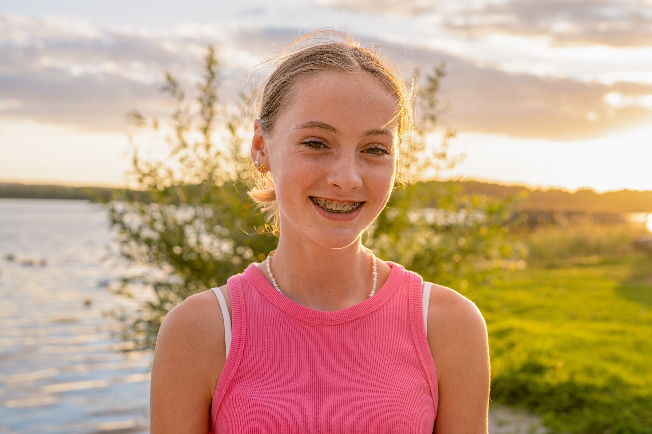 Portrait of a happy smiling teen girl with dental braces in a park.